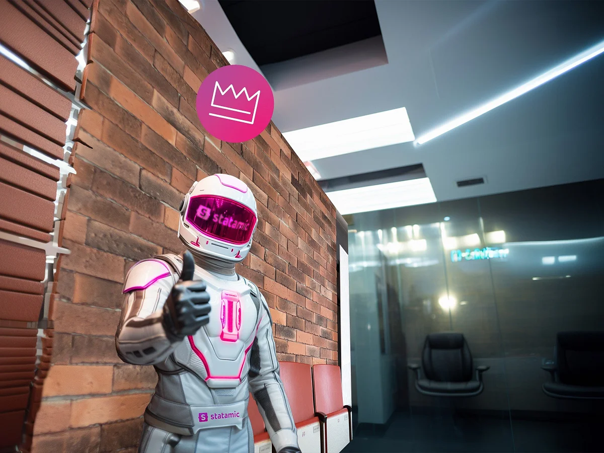 Figur mit Statamic-Helm zeigt den Daumen hoch in einem Büro mit Backsteinwand