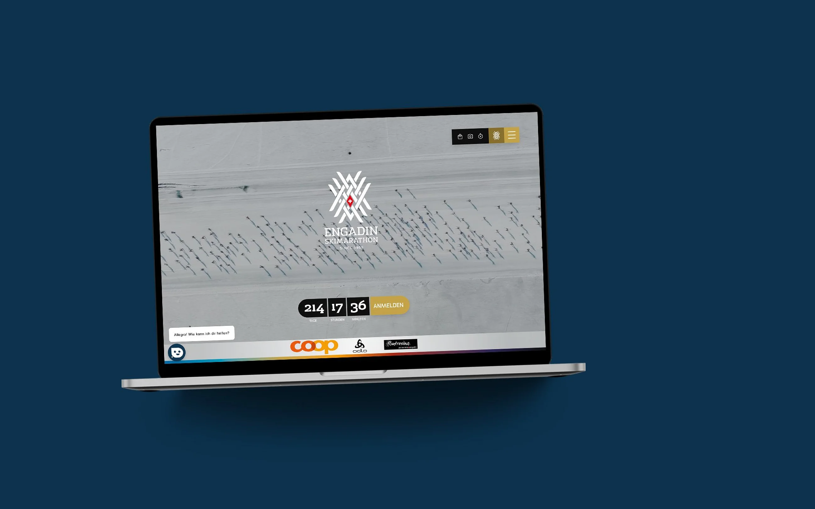 Die ESM-Website im MacBook auf dunkelblauer Fläche: Luftbild der Loipe mit Countdown und Anmeldebutton
