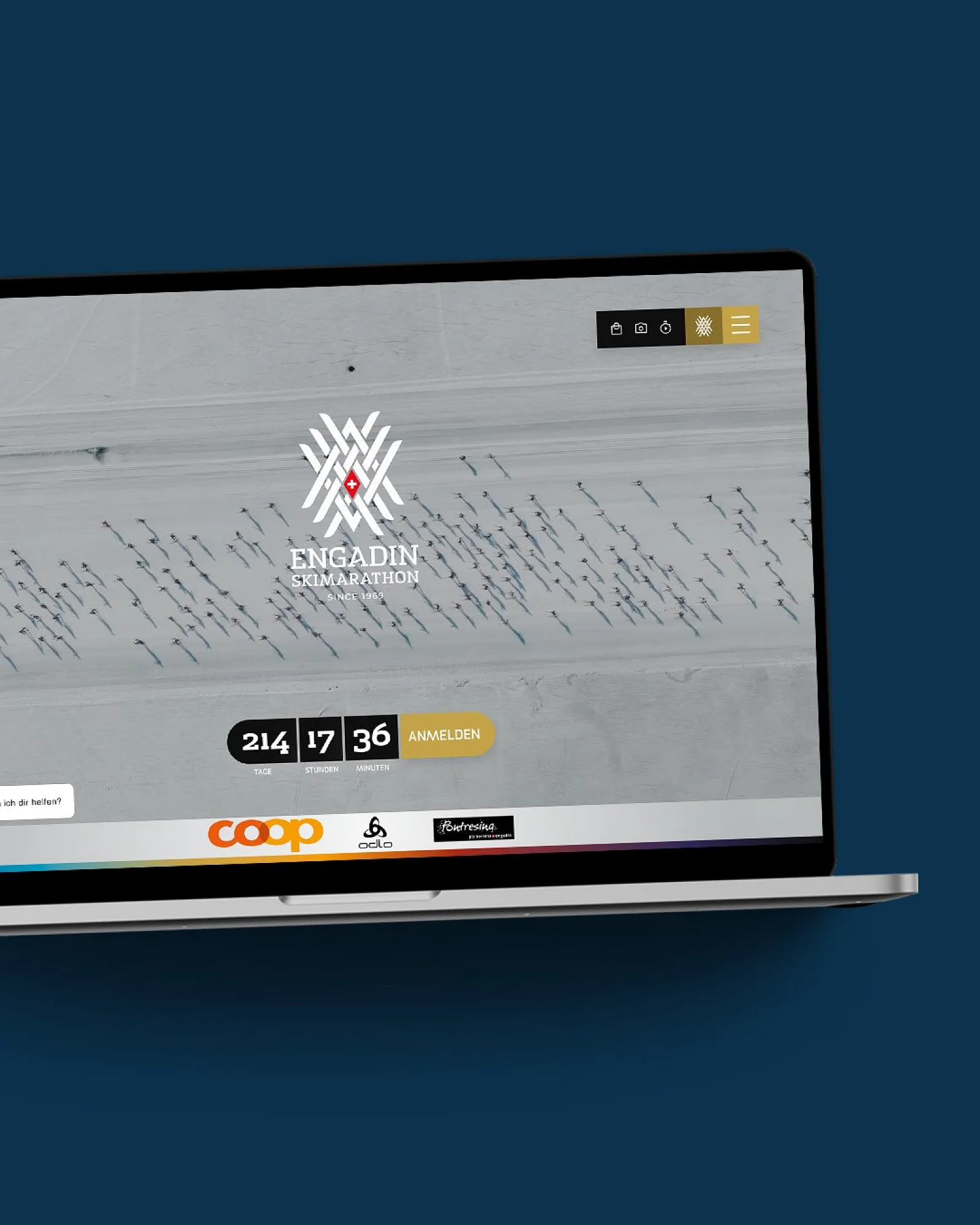 Die ESM-Website im MacBook auf dunkelblauer Fläche: Luftbild der Loipe mit Countdown und Anmeldebutton