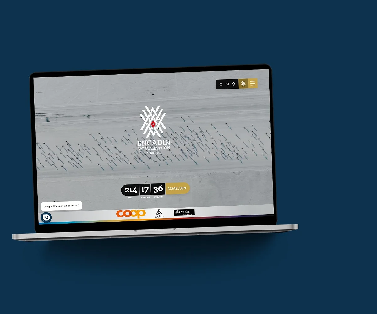 Die ESM-Website im MacBook auf dunkelblauer Fläche: Luftbild der Loipe mit Countdown und Anmeldebutton